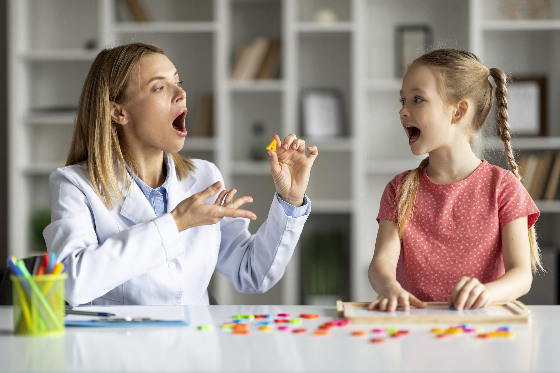 A young girl is engaged in PROMPTs Therapy with a doctor in a doctor's office